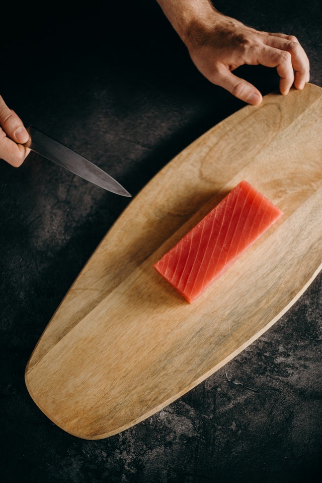 raw salmon on chopping board